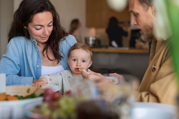couple feeding their child
