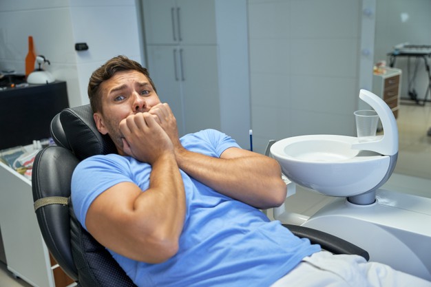 Man-is-afraid-treat-teeth-woman-scared-of-dentists